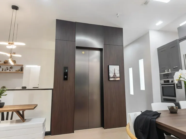 Home elevator with wooden trim and stainless steel door