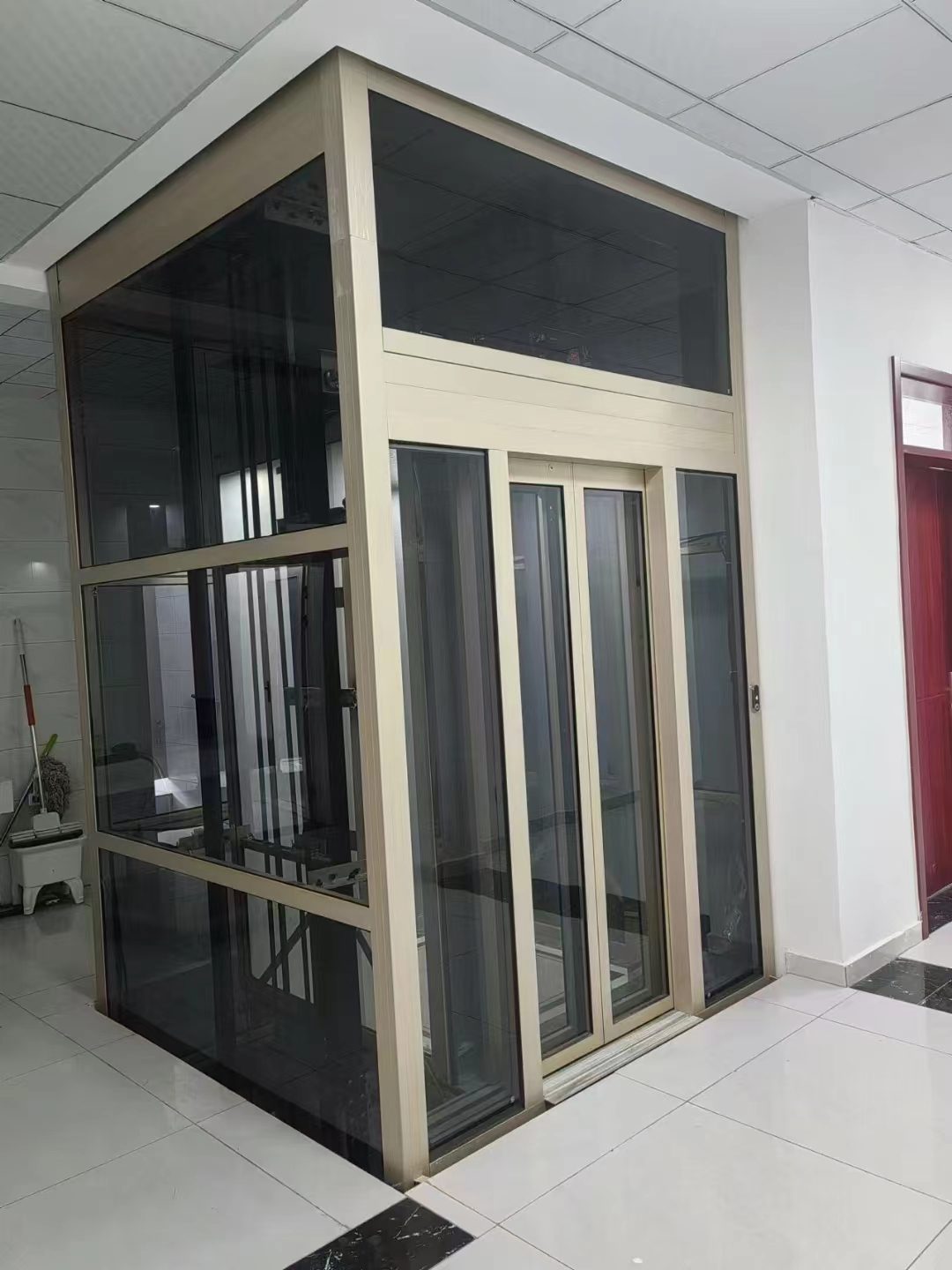 Home elevator entrance flush with the floor for level wheelchair access