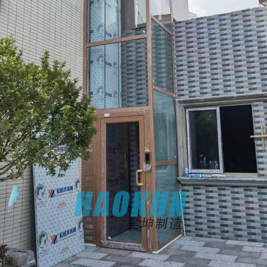 Outdoor installation of a glass home elevator against a building exterior wall