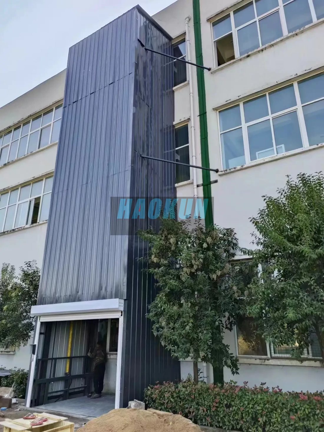 Weather-resistant metal panel enclosure cladding for an outdoor elevator shaft